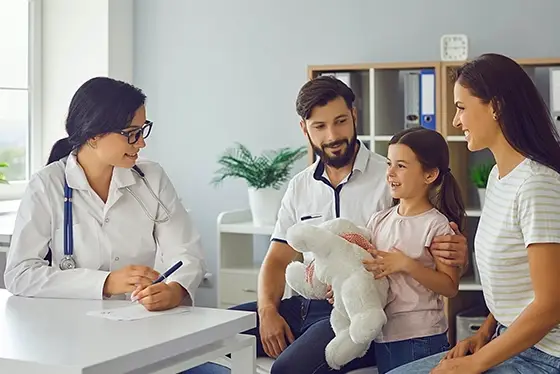 Doctor Consulting a Family About Primary Care in an Office Setting