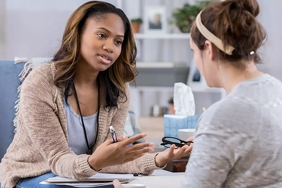 Two women having a thoughtful conversation in a counseling session
