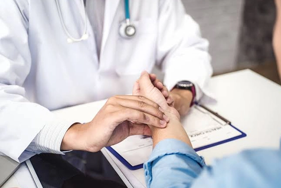 Doctor Holding Patient's Wrist During Urgent Care Consultation